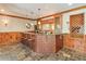Basement bar area features dark countertops, copper-style wall finish, wooden cabinets, and stool seating at 205 Northampton Ct, Canton, GA 30115