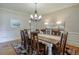 Elegant dining room featuring a chandelier, table set for ten, and views to other rooms at 205 Northampton Ct, Canton, GA 30115