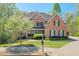Charming brick home with mature trees, landscaped yard, and a well-maintained lawn at 205 Northampton Ct, Canton, GA 30115
