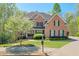 Charming brick home with mature trees, landscaped yard, and a well-maintained lawn at 205 Northampton Ct, Canton, GA 30115