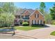Traditional brick home with well-manicured lawn, mature landscaping, and a paved driveway at 205 Northampton Ct, Canton, GA 30115