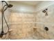 Tiled shower features dual showerheads and a built-in niche for a spa-like experience at 205 Northampton Ct, Canton, GA 30115