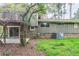 A charming backyard featuring sliding glass doors and a deck above, perfect for relaxation and outdoor enjoyment at 2110 Redbud Sw Ct, Marietta, GA 30008
