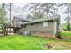 View of the home's backyard and exterior, with a small balcony above a concrete patio at 2110 Redbud Sw Ct, Marietta, GA 30008
