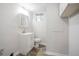 Well-lit bathroom with white vanity, modern fixtures, and wood-look flooring at 2110 Redbud Sw Ct, Marietta, GA 30008