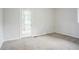 Bright bedroom featuring carpeted floor, neutral paint, a window, and glass door at 2110 Redbud Sw Ct, Marietta, GA 30008