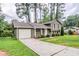 Inviting home with an attached garage and a long driveway, nestled among mature trees in a Gathering-friendly neighborhood at 2110 Redbud Sw Ct, Marietta, GA 30008