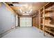 Unfinished garage with overhead lighting and storage shelves at 2110 Redbud Sw Ct, Marietta, GA 30008