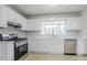 Well-lit kitchen with stainless steel appliances and white cabinets at 2110 Redbud Sw Ct, Marietta, GA 30008