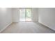 Bright room features neutral walls, carpet, and a sliding door with outside views at 2110 Redbud Sw Ct, Marietta, GA 30008