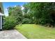 Sprawling backyard with lush greenery and a stone picnic table at 2340 Castleridge Ct, Tucker, GA 30084