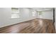 Spacious basement showcasing wood floors, a door to the outside, and white paneled walls at 2340 Castleridge Ct, Tucker, GA 30084