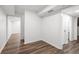 Unfinished basement area featuring wood-look floors and access to another room at 2340 Castleridge Ct, Tucker, GA 30084