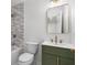 Bathroom boasts modern green vanity, sleek mirror, and bathtub and shower at 2340 Castleridge Ct, Tucker, GA 30084