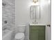Bathroom boasts modern green vanity, sleek mirror, and bathtub and shower at 2340 Castleridge Ct, Tucker, GA 30084