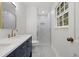 Bathroom features a double sink vanity with blue cabinets and a tiled shower with glass doors at 2340 Castleridge Ct, Tucker, GA 30084