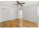 Bedroom with hardwood floors, a ceiling fan, and a closet with white doors at 2340 Castleridge Ct, Tucker, GA 30084