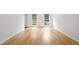 Bright bedroom featuring hardwood floors and two windows for natural light at 2340 Castleridge Ct, Tucker, GA 30084