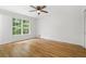 Bedroom showcasing a large window, hardwood floors, and neutral paint, creating a bright and inviting space at 2340 Castleridge Ct, Tucker, GA 30084