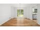 Dining room features hardwood floors, a modern light fixture, and natural light at 2340 Castleridge Ct, Tucker, GA 30084