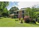 Two-story home featuring brick and siding on a large landscaped lot at 2340 Castleridge Ct, Tucker, GA 30084
