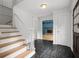 Inviting foyer features a staircase, dark tile flooring, and views into the adjacent living spaces at 2340 Castleridge Ct, Tucker, GA 30084