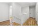 Upstairs hallway with hardwood floors, white railing, and natural light at 2340 Castleridge Ct, Tucker, GA 30084