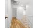 Upstairs hallway with hardwood floors, white railing, and natural light at 2340 Castleridge Ct, Tucker, GA 30084