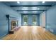 Elegant living room featuring blue walls, hardwood floors, coffered ceilings, and a brick fireplace at 2340 Castleridge Ct, Tucker, GA 30084