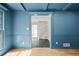 Stylish living room with blue walls, hardwood floors, and an open doorway to the foyer at 2340 Castleridge Ct, Tucker, GA 30084