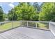 Back deck with white railings, overlooks private fenced-in yard at 243 Hickory Way, Canton, GA 30115