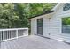 View of the back porch with weathered gray planks, white siding, and a door leading inside the home at 243 Hickory Way, Canton, GA 30115