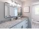 Stylish bathroom features a granite countertop, modern black finishes and a large rectangular mirror at 243 Hickory Way, Canton, GA 30115