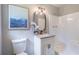 Compact bathroom featuring granite counters, a stall shower, and updated lighting at 243 Hickory Way, Canton, GA 30115