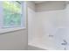 Bathroom with a shower-tub combo, with a shower head and a window view at 243 Hickory Way, Canton, GA 30115