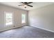 Bedroom with fresh gray paint, ceiling fan, plush gray carpet, and two windows for ample natural light at 243 Hickory Way, Canton, GA 30115