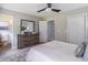 Bright bedroom with a dresser, closet and view into an attached bathroom at 243 Hickory Way, Canton, GA 30115