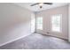 Bedroom with fresh gray paint, ceiling fan, plush gray carpet, and two windows for ample natural light at 243 Hickory Way, Canton, GA 30115