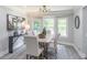 Dining room with modern chandelier, many windows, sleek wood table, and modern decor and lighting at 243 Hickory Way, Canton, GA 30115