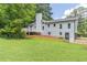 Exterior view of the home showcasing the back deck, white siding, and well-maintained lawn at 243 Hickory Way, Canton, GA 30115