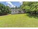 Large, well-manicured front yard with a view of the home's exterior at 243 Hickory Way, Canton, GA 30115