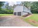 Side view of the home with a two-car garage and a well-maintained lawn at 243 Hickory Way, Canton, GA 30115