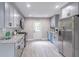 Updated kitchen with sleek gray cabinets, stainless steel appliances, granite countertops, and light wood flooring at 243 Hickory Way, Canton, GA 30115