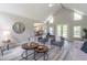 Bright living room with vaulted ceilings, gray walls, updated floors, and natural light from double doors and large windows at 243 Hickory Way, Canton, GA 30115