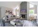 Spacious living room with stone fireplace, complemented by stylish decor and ample natural light at 243 Hickory Way, Canton, GA 30115