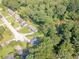 Aerial view of homes situated around a winding creek amidst lush greenery and trees at 3109 Albatross Ln, Decatur, GA 30034