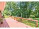 Red stained deck overlooking the private, tree-lined backyard at 3109 Albatross Ln, Decatur, GA 30034