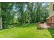 Large, grassy backyard and red wood deck offering ample space for outdoor activities at 3109 Albatross Ln, Decatur, GA 30034