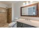 Bathroom with tiled stand-up shower and elegant vanity with a large framed mirror at 3109 Albatross Ln, Decatur, GA 30034