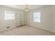 Bedroom with a decorative light fixture, neutral carpet and shelving at 3109 Albatross Ln, Decatur, GA 30034
